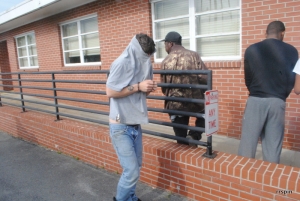 Timberlake covers his face as he is led to the sheriff&#039;s office.