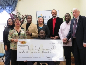 Members of the school board pose with the promotional check and representatives from GCF.