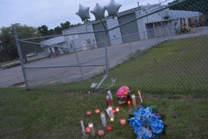 Candles and flowers mark the scene of the fatal crash.
