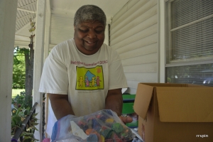 Robinson shows a donation of used crayons from Belmont which will be used at the camp.
