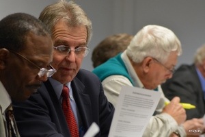 Councilman Carl Ferebee, left, and Mayor Emery Doughtie look at budget information.