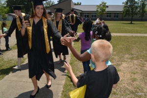 Belmont students extend their hands to a graduating senior.