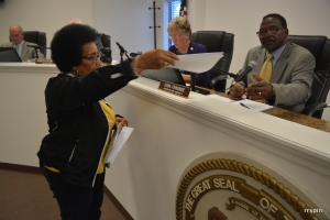 Ruby Mason hands Ferebee a petition.