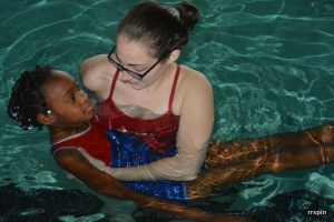 Lifeguard Holli Parks helps a student.