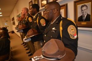 The Northampton County Sheriff&#039;s Office Honor Guard listens to speakers this evening. They are wearing black bands across their badges to remember the late Woodland police Chief Don Ryan and Sergeant Meggan Callahan, a correctional officer in Bertie County who was fatally assaulted by an inmate last month.