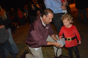 Parks and recreation Director John Simeon holds the box as Madelyn presses the button to light the tree.