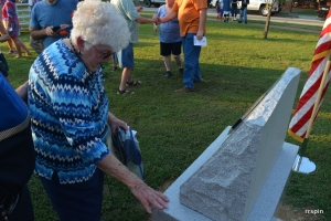 Burnette places her hand on the memorial following the ceremony.