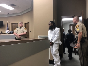 West enters the courtroom, shortly before proclaiming his innocence.