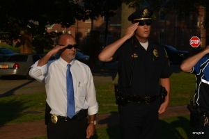 Investigator Jeff Davis and Sergeant Mike Moseley salute during the dedication of the Fallen Officers Memorial at Centennial Park in 2016.