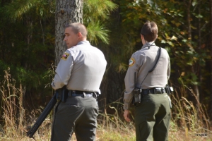 An armed trooper and park ranger stand watch at the perimeter.
