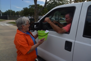 Sue Owens collects money from her son, Steve, during a roadside collection effort.