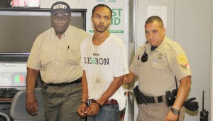 Daye is escorted by Smith, left, and Deputy Jorge Lewis.