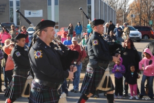 The Greenville Public Safety Pipes &amp; Drums marches down the avenue.